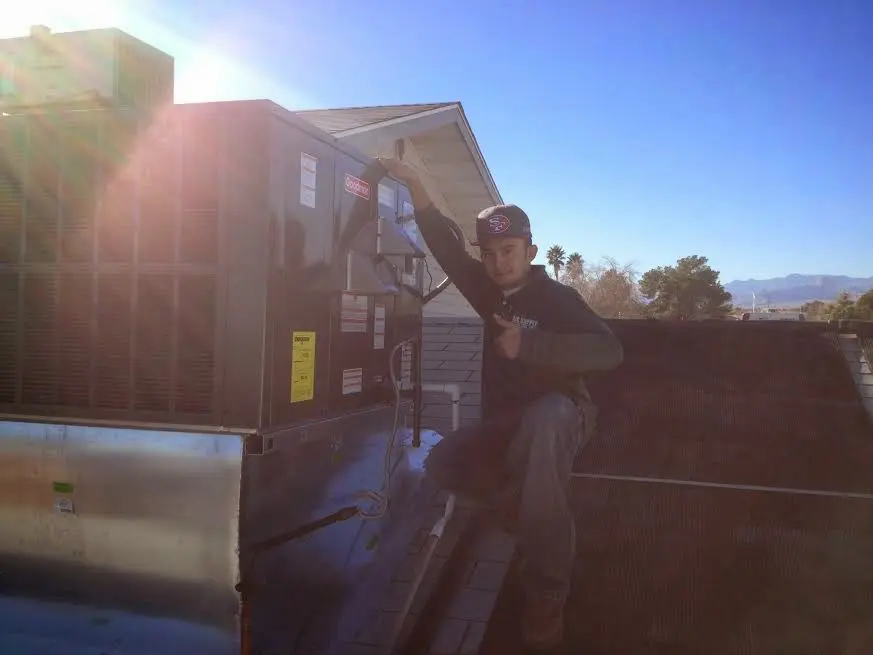 HVAC technician performing HVAC Inspection on a rooftop unit in Blanchard